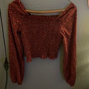 red crop top with loose sleeves